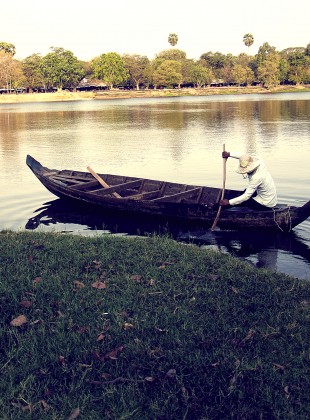 Dugout Canoe being paddled across the moat at Angkor.