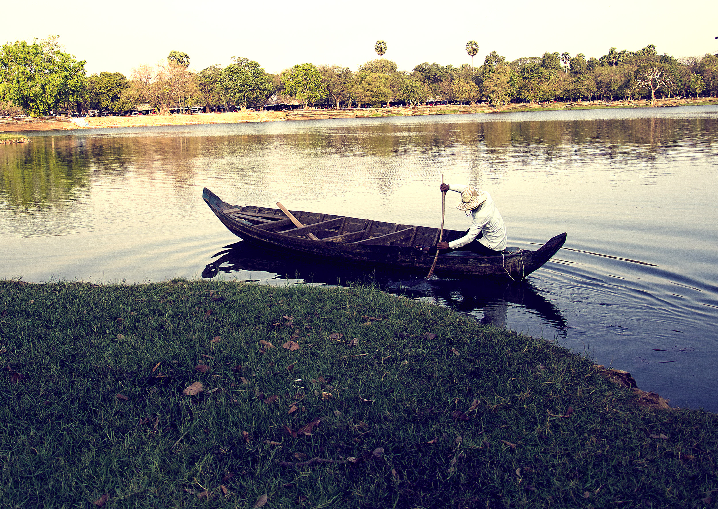 Dugout Canoe being paddled across the moat at Angkor.