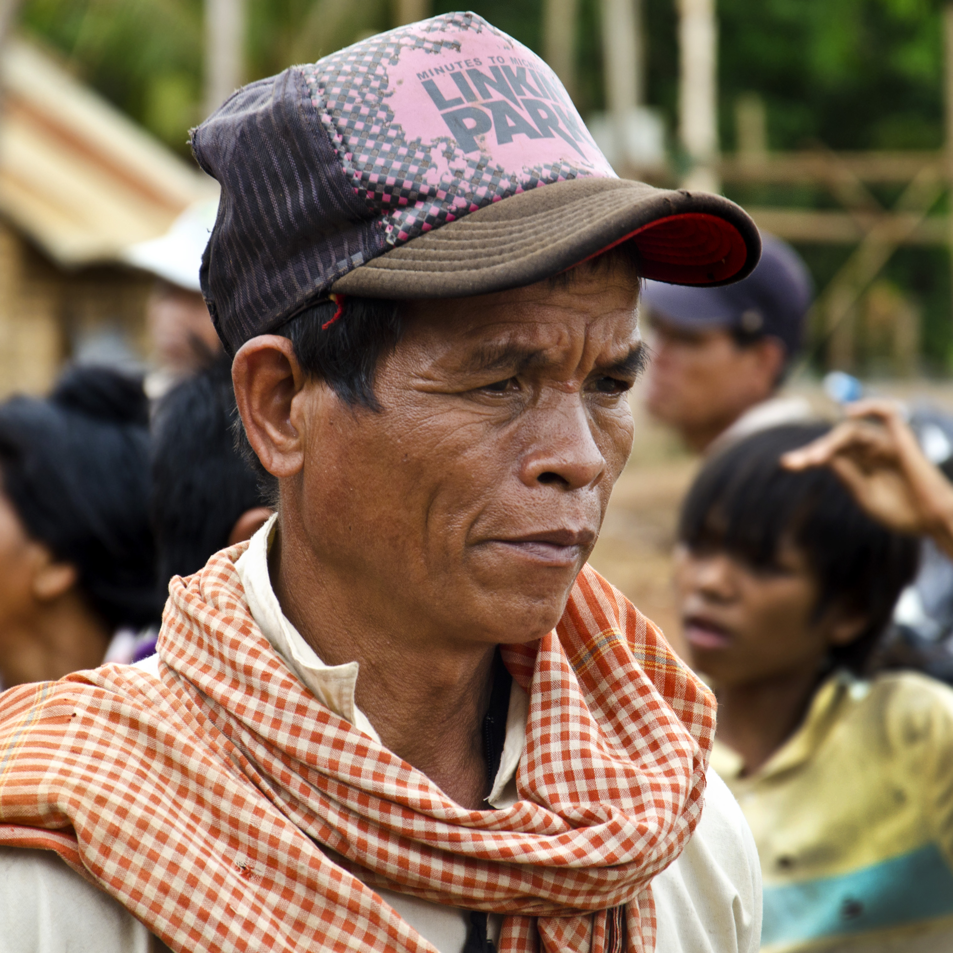 indigenous krung hilltribe man wearing a linkin park hat