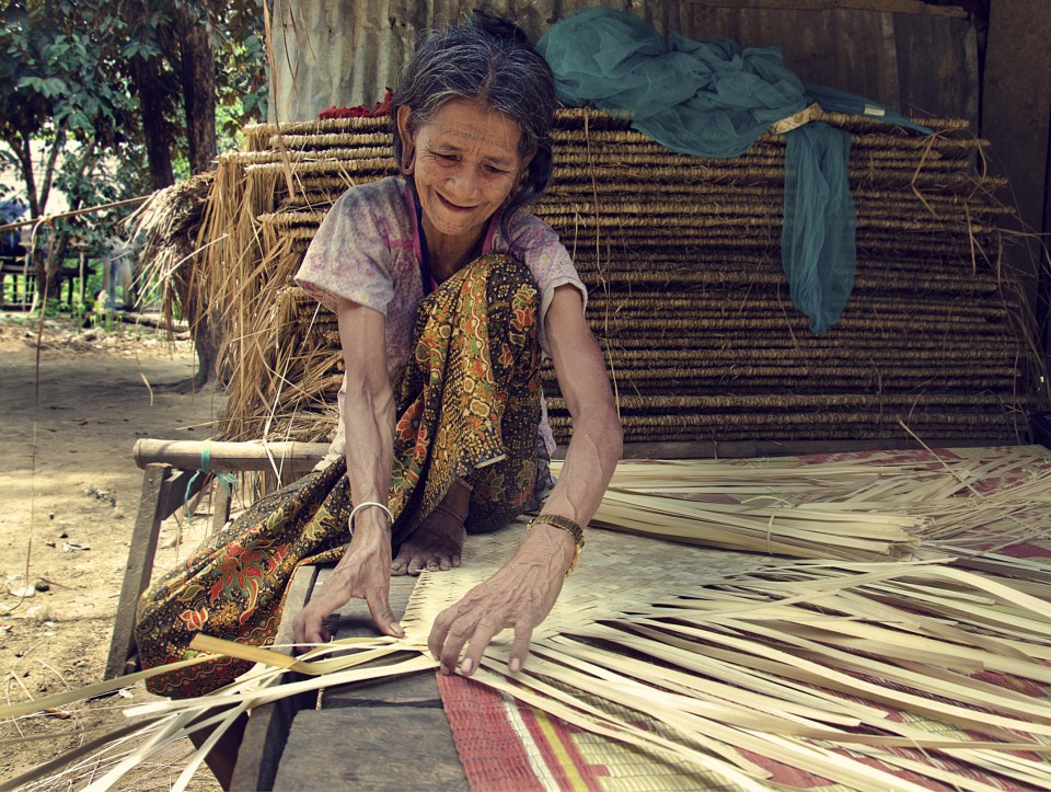 weaving a mat out of palm fronds