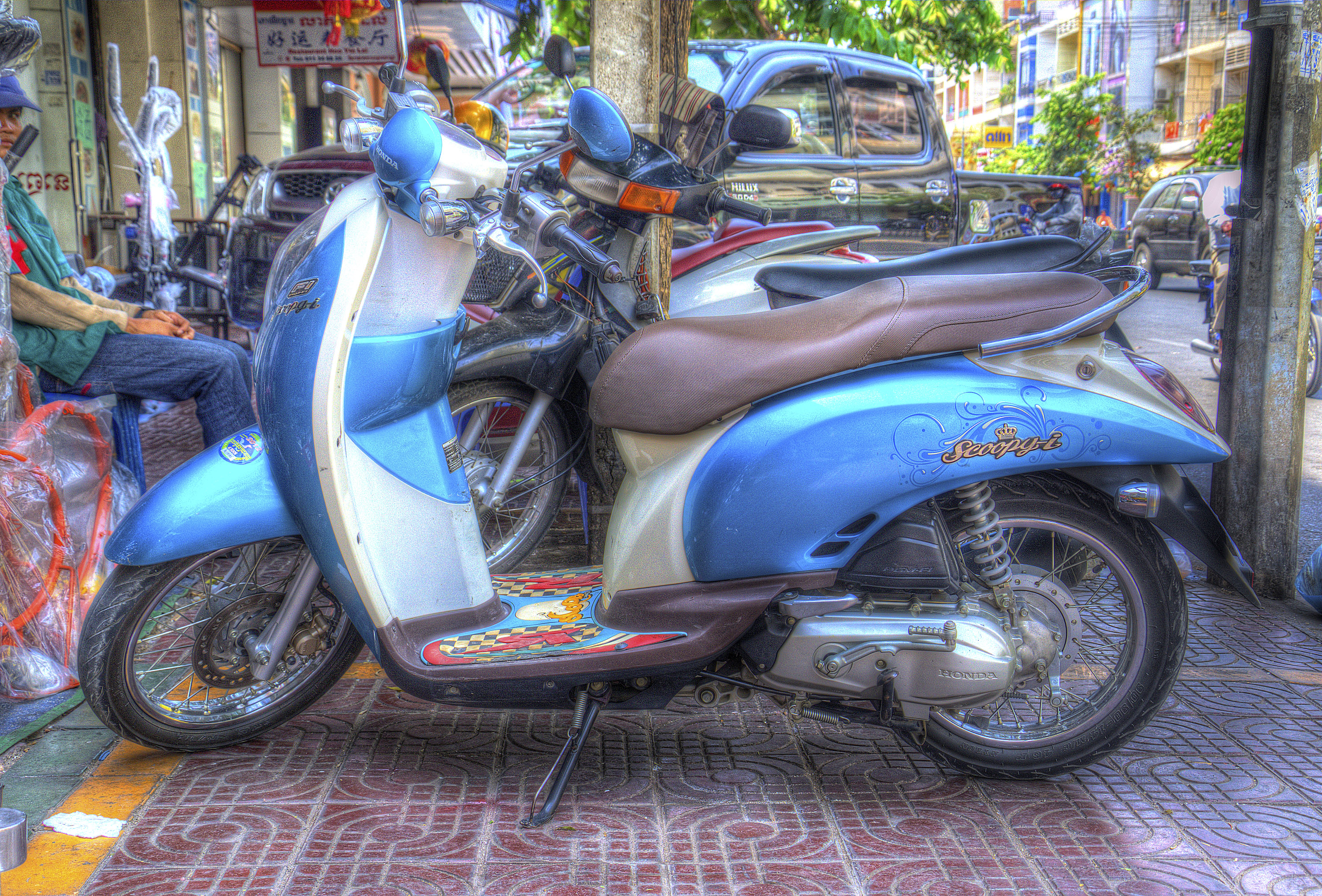 One of the ubiquitous scooters scurrying through the streets of any Southeast Asian City
