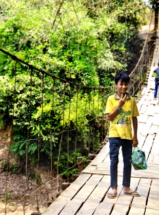 Kreung boy on swinging rope bridge