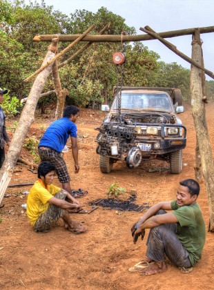 taking apart an engine by the side of the road in ratanakiri.