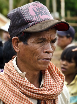 indigenous krung hilltribe man wearing a linkin park hat
