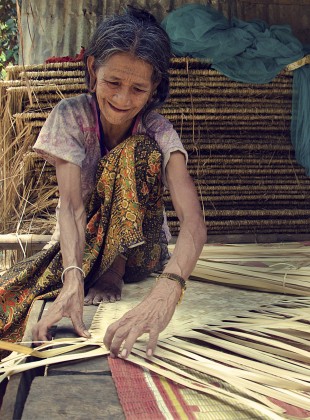 weaving a mat out of palm fronds